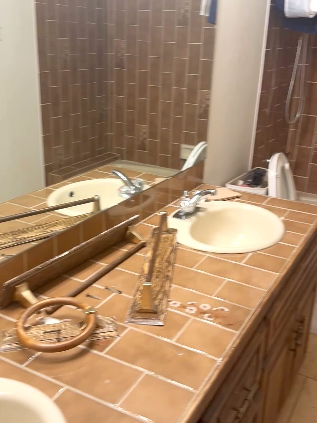 Bath with a tiled vanity counter and brown wall tile before renovation