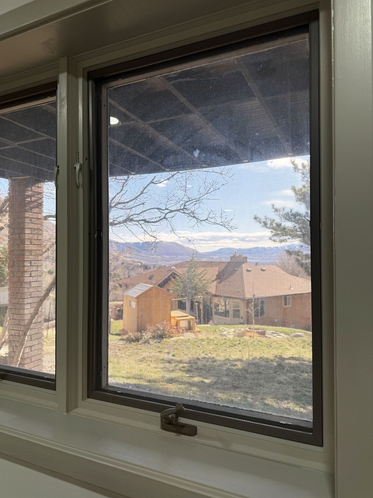 Window looking out over the neighborhood toward the mountains
