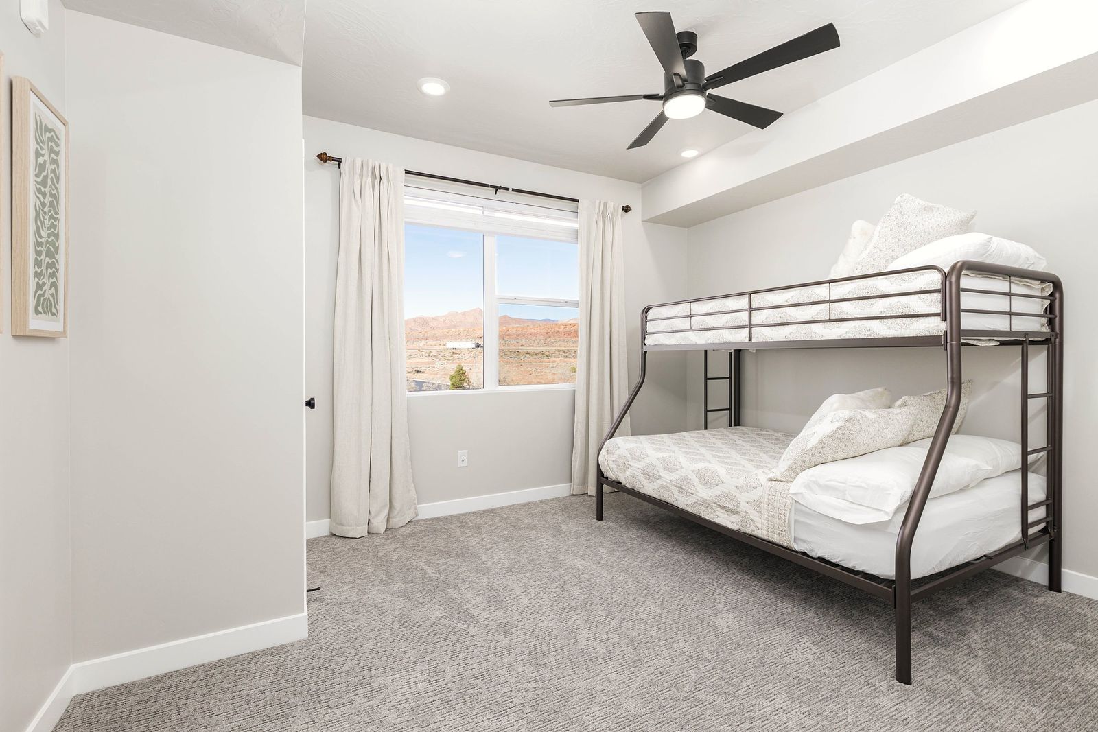 Bunk room with a black metal twin-over-full bunk bed