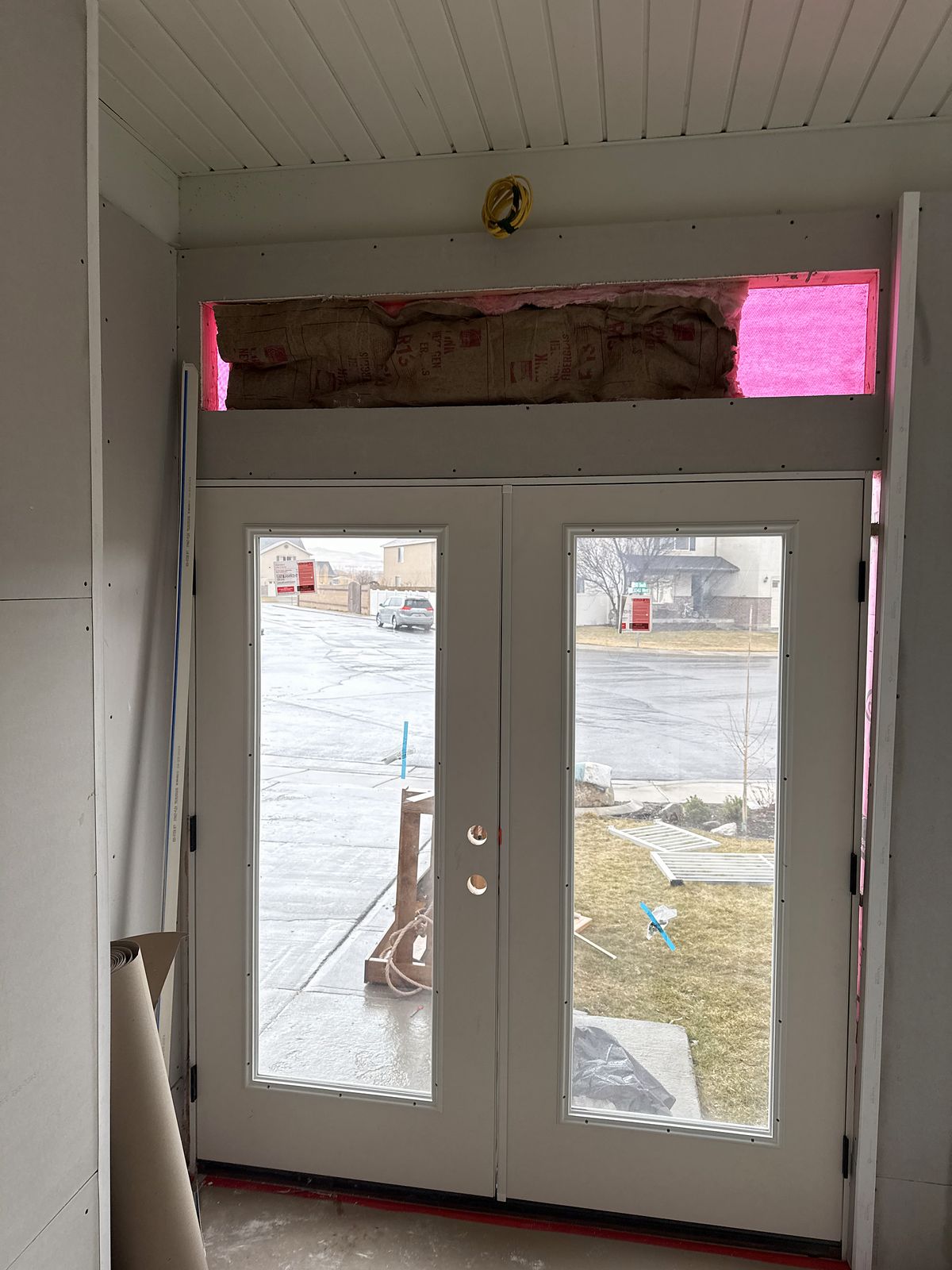 Inside the new enclosure looking out through the new French doors, before finishes